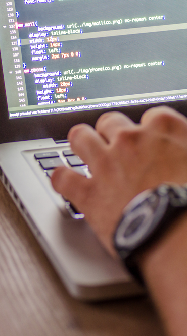 A man programming on his laptop